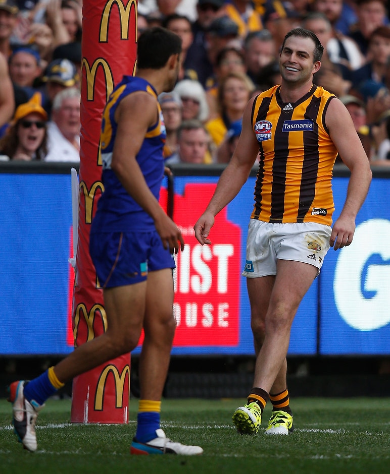 2015 Toyota AFL Grand Final - Hawthorn v West Coast MELBOURNE, AUSTRALIA - OCTOBER 3: Josh Hill of the Eagles kick for goal is touched by Brian Lake of the Hawks during the 2015 Toyota AFL Grand Final match between the Hawthorn Hawks and the West Coast Eagles at the Melbourne Cricket Ground, Melbourne, Australia on October 3, 2015. (Photo by Sean Garnsworthy/AFL Media)